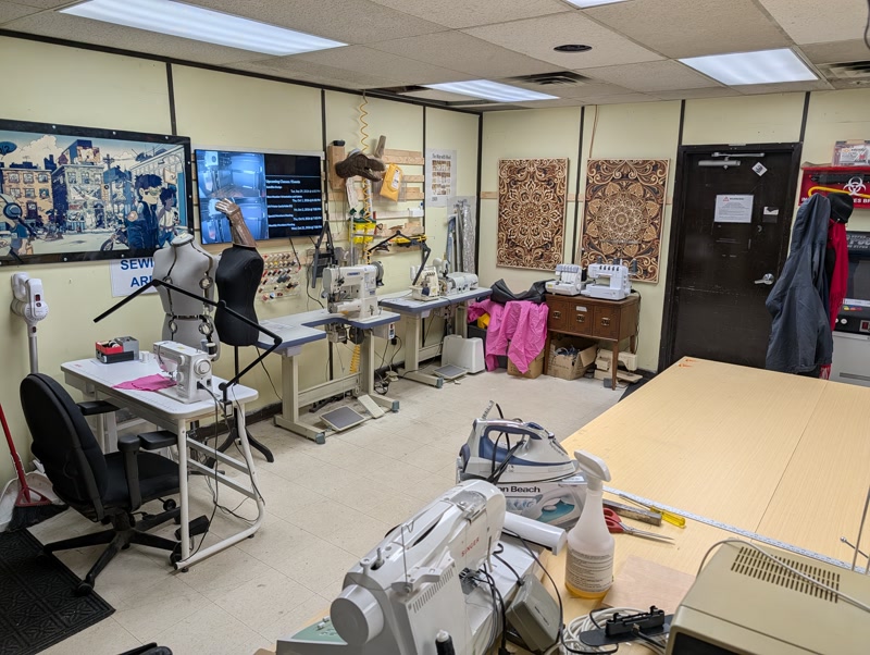 Sewing room overview with industrial and domestic sewing machines